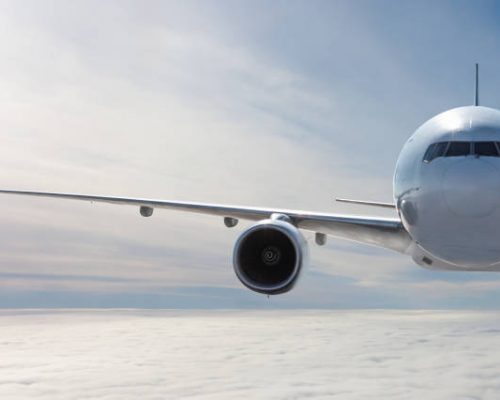 aviation sAF Front view of the white wide body passenger aircraft flies in the air above the clouds