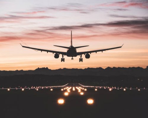 An airplane moments from touching down on the runway at sunrise. An airplane moments from touching down on the runway at sunrise.